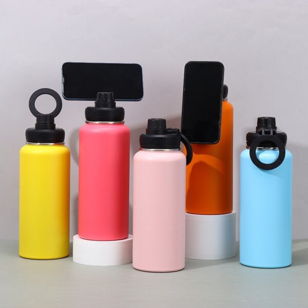 Water bottle with magnetic phone holder